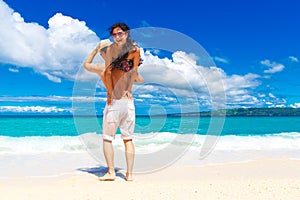 Young loving couple having fun in the tropical beach