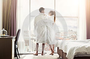 Young loving couple in hotel room in the morning