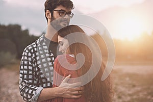 Young loving couple hugging outdoors