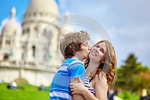 Young loving couple kissing near the Sacre-Coeur