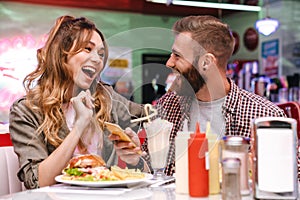 Young loving couple listening music with earphones