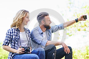 Young loving couple making selfie photo outdoor.