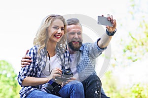 Young loving couple making selfie photo outdoor.