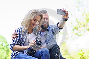 Young loving couple making selfie photo outdoor.