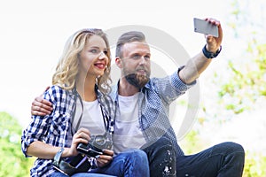 Young loving couple making selfie photo outdoor.