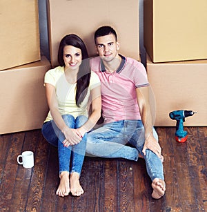 Young loving couple moving to a new house. Home and family concept.