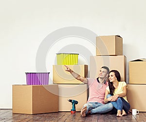 Young loving couple moving to a new house. Home and family concept.