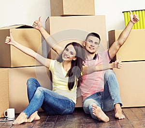 Young loving couple moving to a new house. Home and family concept.