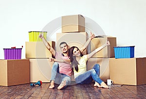 Young loving couple moving to a new house. Home and family concept.