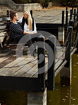 Young loving couple in park by lake