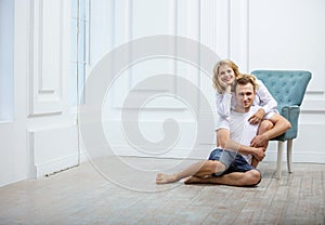 Young loving couple posing indoors