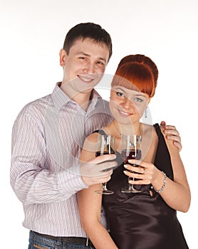 Young loving couple with red wine glasses in hands