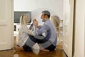 Young loving couple sitting on the floor