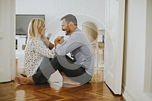 Young loving couple sitting on the floor