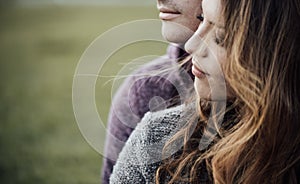 Young loving couple sitting on the grass