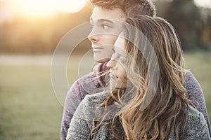 Young loving couple sitting on the grass