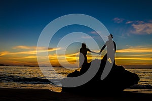 Young loving couple on wedding day on tropical beach and sunset