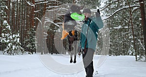 A young loving millennial man is playing or training his new dog