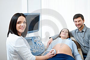 Young loving pregnant couple visiting doctor together