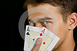 Young lucky gambler with cards