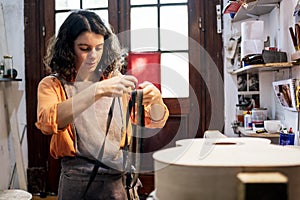 Young Luthier Working In Her Workshop