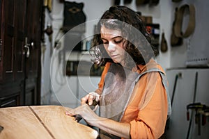 Young Luthier Working In Her Workshop