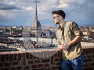 Young ma posing in Turin, Italy with Mole Antonelliana