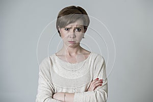 Young mad angry and upset red hair woman posing sad and moody looking to camera isolated on grey background in facial expressions