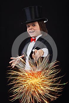 Young magician boy using his magic wand