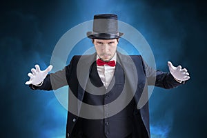 Young magician man is showing magic trick