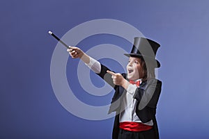 Young magician performing with a magic wand