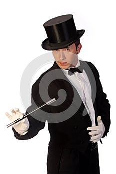 Young magician performing with wand photo