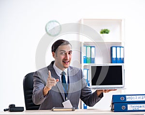 Young male accountant working in the office