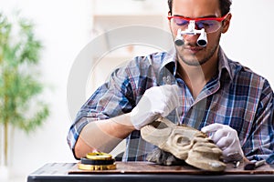 Young male archaeologist studying ancient african stonemask