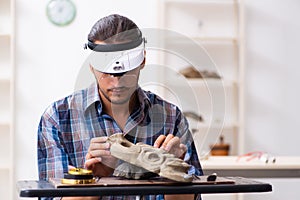 Young male archaeologist studying ancient african stonemask