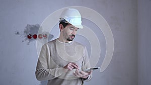 Young male architect inspecting the construction site