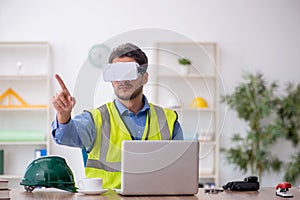 Young male architect wearing virtual glasses