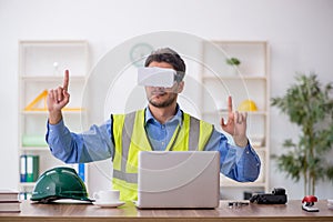 Young male architect wearing virtual glasses