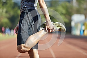 Young male athlete warming up during training