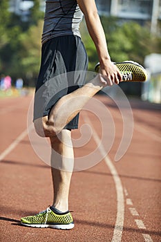 Young male athlete warming up during training