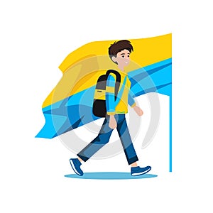 Young male with backpack walking confidently with large flag. Casual dressed teenager carries national flag on his