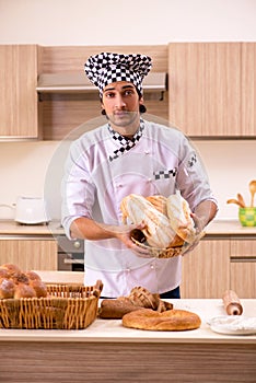 The young male baker working in kitchen