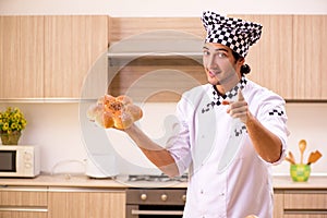 The young male baker working in kitchen