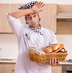 Young male baker working in kitchen