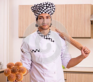 Young male baker working in kitchen