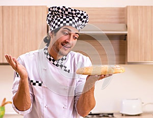 Young male baker working in kitchen