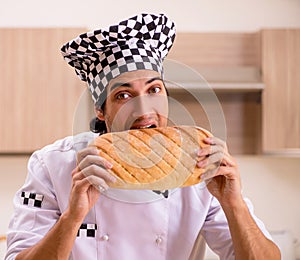 Young male baker working in kitchen