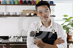 Young male Bartender in cafe restaurant.