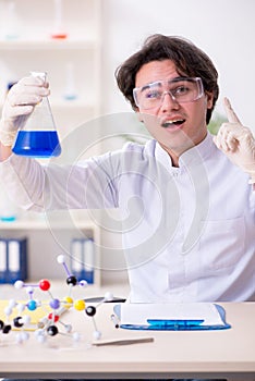 Young male biochemist working in the lab