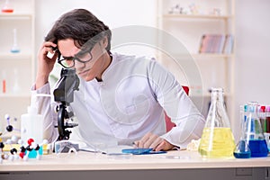 Young male biochemist working in the lab